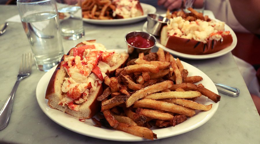 Neptune Oyster signature dishes Maine Lobster Roll (served hot with butter or cold with mayo)Neptune JohnnycakeWellfleet Clam Chowder